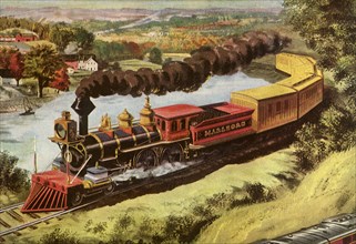 A train billowing black smoke passes through the countryside.