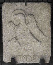 Stone slab showing a haloed eagle symbolizing Saint John