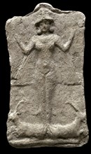 Terracotta relief with depiction of a one winged goddess, standing on two ibexes