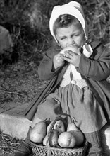 little girl eating pear, 1949