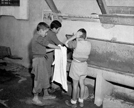 italy, the child village, children washing, 1946