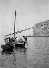 sardaigne, alghero, pêcheurs au repos dans une barque, 1900 1910