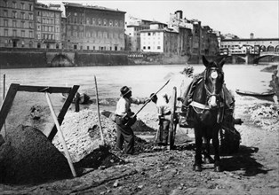 italie, toscane, arno renaioli au travail près du vieux pont, 1920 1930