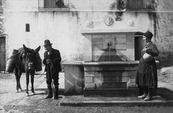 italia, basilicata, colobraro, scene di vita attorno alla fontana di via vittorio veneto, 1930