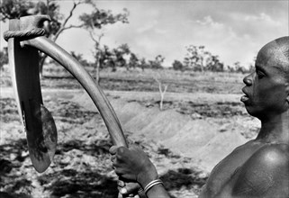 africa, togo, un konkomba con una vanga primitiva, 1930