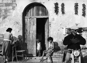 family in front off the house, cosenza, calabria, italy, 1957