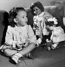 petite fille sur le canapé avec ses jouets, 1955