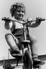 enfant sur un tricycle, 1949
