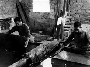 Paper Recycling. Processing Of The Mass Of Paper Dissolved In A Tub. China 1940-50