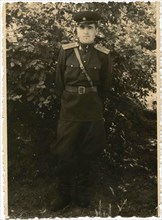 Soviet Army lieutenant against a background of bushes.