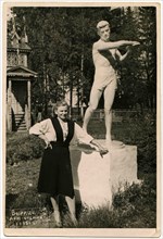 A young woman near the monument discus thrower.