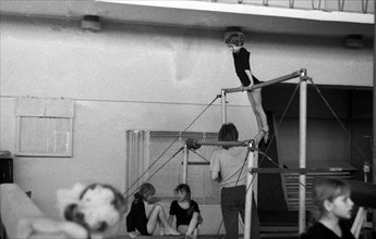 Girls on the uneven bars at sports school.
