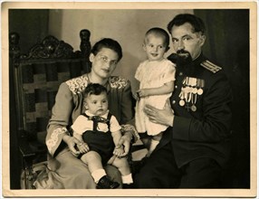Cabinet photo of the family of colonel of the Soviet Army, awarded orders and medals.