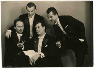 Cabinet photo of four men in evening dress.
