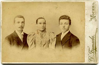 An antique photo shows two young men and young woman, the end of 19 - early 20century. Russian text: Butaev (photo); Moscow.