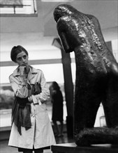 A visitor in front of a Brancusi sculpture.