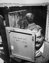 The American actor Zero Mostel while he paints his self-portrait.