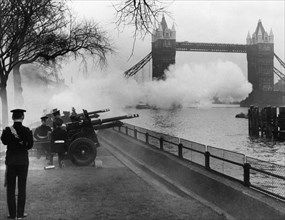 Cannon firing in honor of the queen against the background of tower bridge.