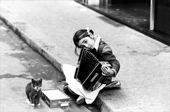 Little Gypsy With An Accordion Asking For Alms.