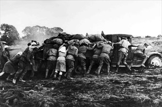 Farmers Help Soldiers Pushing A Truck Loaded In The Russian Steppe.