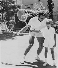 Charlton Heston Plays Tennis With His Son Fraser.