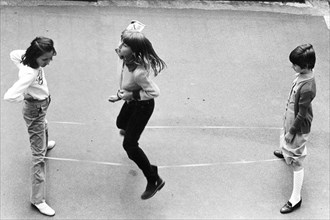 Italy, girls play with elastic, 1970