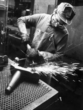 Metal worker in a factory, Italy 70's