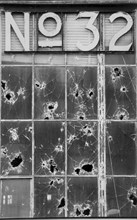 Window with broken glass from bullets, new york city, 1981