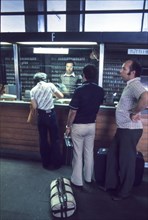 Central station of milan, passengers at ticket office , 70's