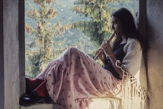 Young woman playing flute, 70's