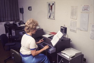 Secretary using telex, 70's