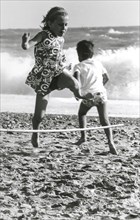 Children playing on the beach, 70's