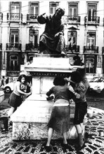 6th october 1974, portugal, lisbon, people cleaning monument of city