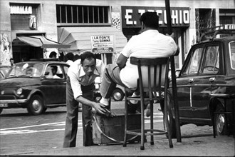 Shoe polisher in a naples's street, italy, 70's