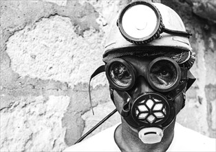 Miner of solfara vodi wearing a gas mask, assoro, sicily, 70s