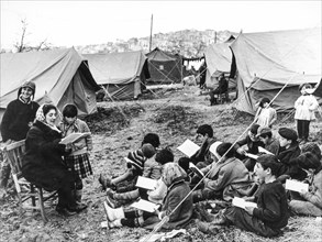 Evacuees of agrigento's landslide, children during a school lesson in the campings, 1966