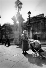 Homeless woman in front of the royal palace of london, uk, 70's