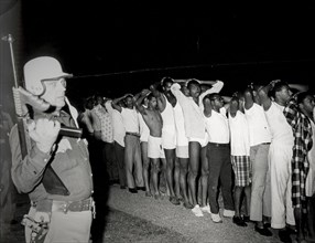 Students of texas southern university keep their hands behind their heads as they await transportation to jail, houston, 1967
