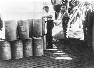 De Pinedo during a stop oversees the refueling of oil, in the absence one needed castor oil bought from local pharmacists, 1927