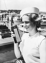 A model test a new walkie talkie for civilian use, 1962