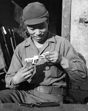 Soldier Examines Prize Pistol