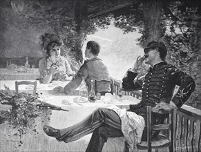 Young Couple Sitting In A Garden Restaurant