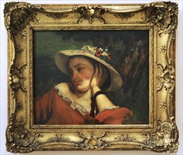 Woman in a straw hat with flowers.