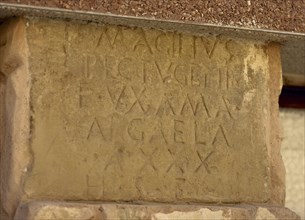 Roman inscription in capital letter on the wall of a house.