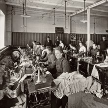 Women sewing at a sewing workshop of the Singer Society circa 1904