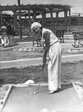 Woman Playing Miniature Golf