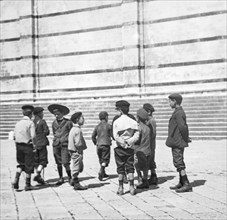 A group Of Children In Italy Talking And Playing.