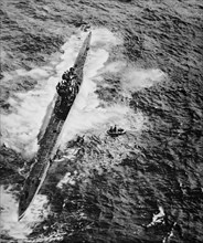A U boat surrenders to a coastal command Hudson Aircraft after being machine gunned.