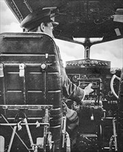 R.A.F pilot at the controls of a Flying Fortress.