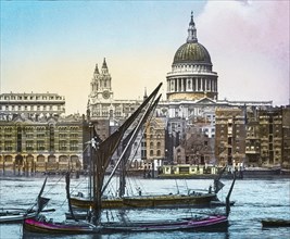 St Paul's cathedral from the Thames with sailing boats near St Paul's Pier.